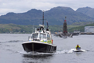 A launch from the Ministry of Defence Police Marine Unit Clyde, escorts a Trident submarine out to sea. 10 February 2005. Source: http://commons.wikimedia.org/wiki/File:MOD_Police_Escort_Trident_submarine_Leaving_Faslane_MOD_45144050.jpg Photo: Paul Kemp/MOD